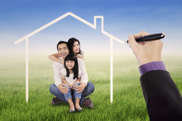 Obraz premium Little happy family with a dream home