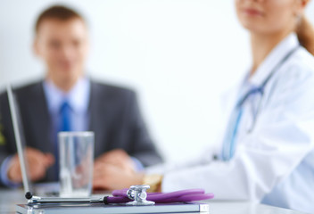 Medical team sitting at the table in modern hospital