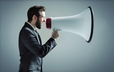 Conceptual photo of man yelling over the megaphone - obrazy, fototapety, plakaty