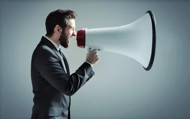 Poster Conceptual photo of man yelling over the megaphone © konradbak