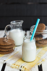 Rustic home made cookies on the wooden background with milk