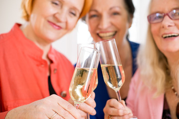 Smiling Mom Friends Tossing Glasses of Champagne.