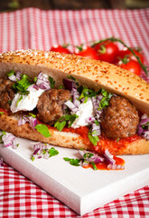 Meatball sandwich with tomato sauce and sour creme