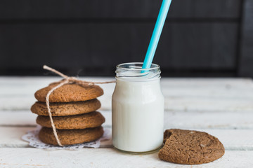 Rustic home made cookies on the wooden background with milk