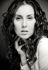 Portrait of pretty young woman with curly hair.