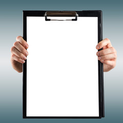 Female hands holding medical clipboard with blank sheet of paper