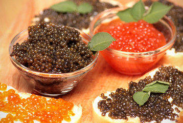 Black and red caviar in glass container