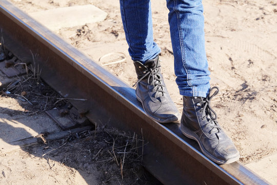 Girl legs on the railway tracks