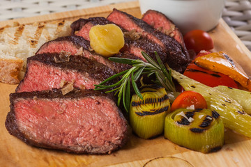 Grilled beef steak on wooden board