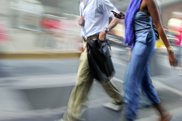 motion blurred business people walking on the street