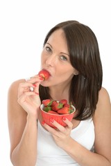 Healthy Young Woman Holding a Bowl of Fresh strawberries