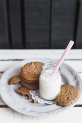 Rustic home made cookies on the wooden background with milk