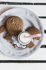 Rustic home made cookies on the wooden background with milk