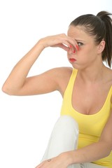 Portrait of an Attractive Young Woman Holding Her Nose