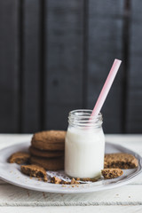 Rustic home made cookies on the wooden background with milk