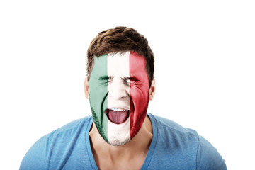 Screaming man with Mexico flag on face.