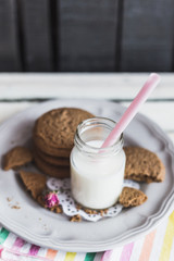 Rustic home made cookies on the wooden background with milk
