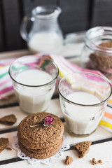 Rustic home made cookies on the wooden background with milk