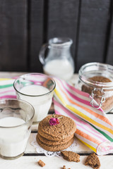 Rustic home made cookies on the wooden background with milk