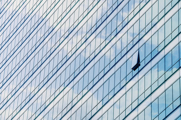 Clouds reflected in windows of modern office building