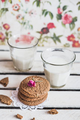 Obraz na płótnie Canvas Rustic home made cookies on the wooden background with milk