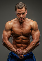Fototapeta na wymiar Muscular man posing in studio