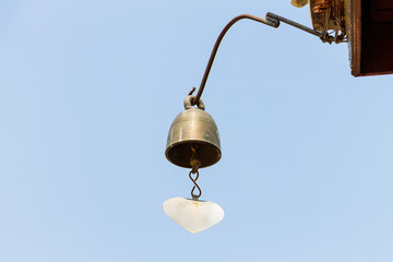 Bells of Buddhist temple on blue sky background