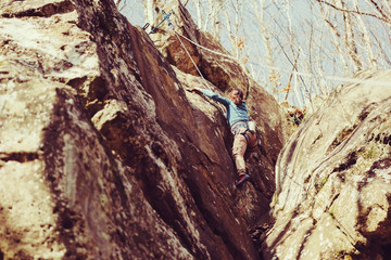 Girl climbing rock outdoor
