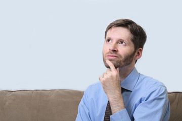 Business man with beard and hand on chin thinking
