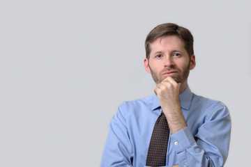 Serious business man with hand on chin
