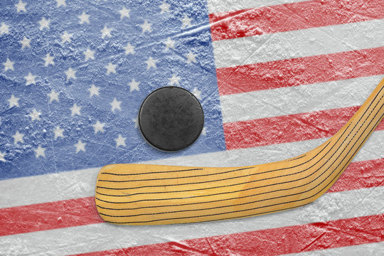 Hockey puck, stick and American flag