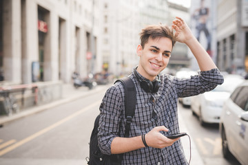 young handsome alternative dark model man in town listening to m