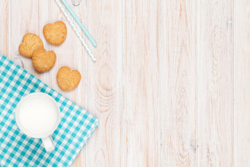 Fototapeta na wymiar Cup of milk and heart shaped cookies