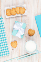 Cup of milk, heart shaped cookies, gift box and notepad