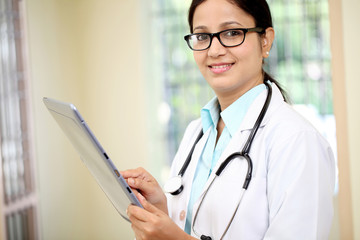 Female doctor using tablet computer