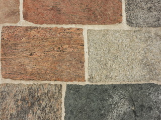 Granite stone wall background in grey and pink-brown