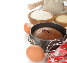 Chocolate cake and ingredients for baking