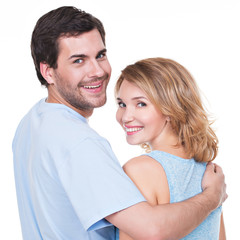 Back view of young couple in embrace.