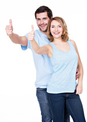 Portrait of happy couple with thumbs up.