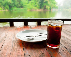 Fresh cola drink on wood table