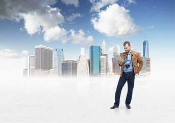 Handsome tourist man is examining the map. 