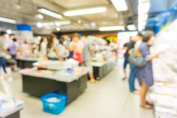 Fototapeta premium Abstract blurred people walking in book shopping center