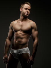 Fototapeta premium Man in white panties posing in studio
