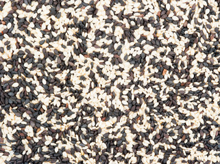 black and white sesame seeds isolated on white background