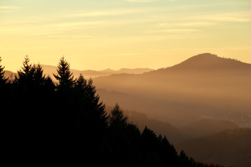 sunset over misty mountains