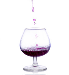 Red wine up with drops on white background
