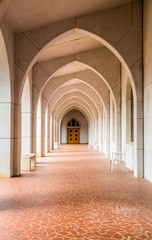 Chair by Arches Over Tile Walkway