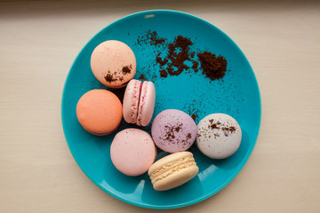 Beautiful Multicolored Macarons on the plate with coffee