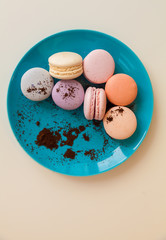 Beautiful Multicolored Macarons on the plate with coffee