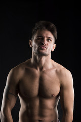 Fototapeta premium Handsome muscular, shirtless man looking up